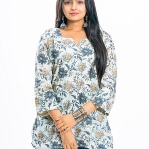 Chic woman in floral tunic and jeans, showcasing modern fashion.